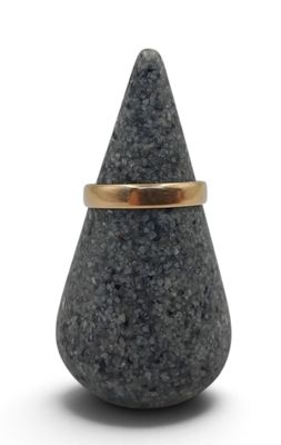 an image of a gold ring on a black stone