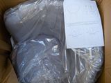 a cardboard box containing a toilet and a sheet of paper