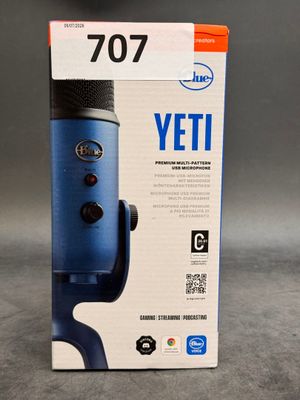 an image of a blue microphone sitting on top of a box