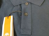 a blue polo shirt with a yellow tree on it