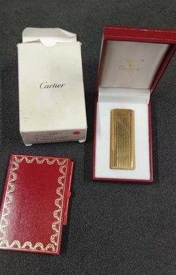 a close up of a box with a lighter in it on a table