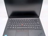 a black laptop with a red button on the keyboard
