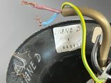 a close up of a black bowl with a yellow wire in it