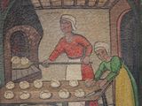 a painting of a woman making bread in a kitchen