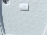 a white refrigerator that is sitting in a plastic bag