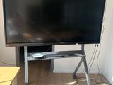 un téléviseur à écran plat posé sur un support dans une pièce