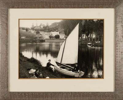 a black and white photo of a sailboat on the water
