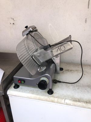an image of a meat slicer sitting on top of a counter