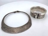 two silver rings and a silver ring on a white table
