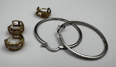 two rings and a bracelet are sitting on a white surface