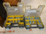 two yellow boxes filled with screws and nuts on the floor