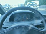 dashboard of a car with a steering wheel and dashboard gauges