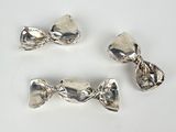 three pieces of silver metal with a bow on top of them
