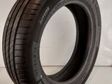 a close up of a tire on a white surface next to a pair of scissors