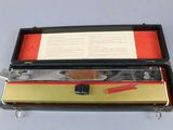 a box with a pencil, ruler, and other items in it