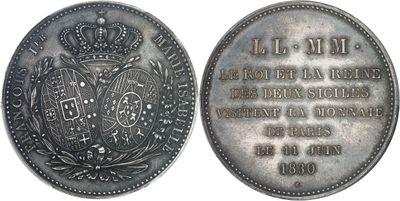 an old silver coin with a crown on the front and a plaque on the back