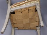 a chair made out of cardboard with a basket on top of it