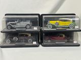 three model cars are in a display case on a white surface