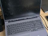 a laptop computer sitting on top of a wooden desk