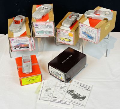 de nombreux modèles réduits de voitures dans des boîtes posées sur une table