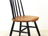 a wooden chair with black legs and a wooden seat