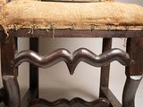 a wooden chair with a cushion on top of it