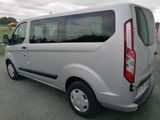 a silver van that is parked in the parking lot