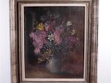 a painting of flowers in a vase on a easel