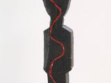 a wooden sculpture of a man with a snake on it ' s head