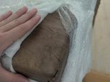 a person holding a piece of wood in a box