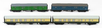 four toy train cars are lined up on a white surface