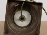 a metal object with a green cord in it