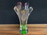 a glass vase that is sitting on a wooden table