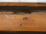 a piece of wood that is missing from the top of a bed