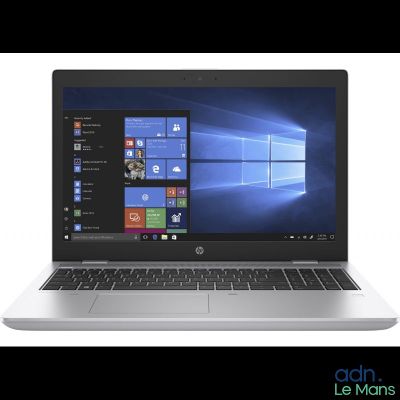 a close up of a laptop on a white surface with windows on the screen
