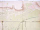 an old map of a town on a piece of paper on a table