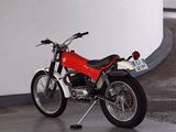 a red motorcycle parked in a parking garage
