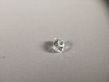 a close up of a white diamond on a white surface