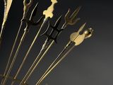 brass sculpture of a bunch of forks and spoons on a stand
