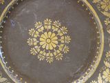 a brown plate with a yellow flower design on it