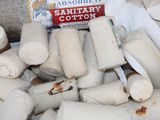 a pile of toilet paper rolls and a box of toilet paper