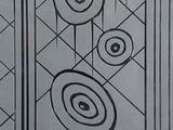 a black and white picture of a door with a design on it