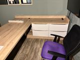 a purple chair sitting in front of a computer desk