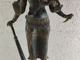 bronze statue of an indian god holding a staff and a bird
