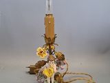 a lamp that is sitting on a table with flowers on it