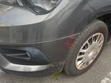 a grey van that is parked in a parking lot