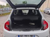 a white car with its trunk open in a parking lot