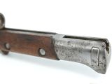 an old knife with a wooden handle on a white surface