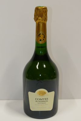 a bottle of champagne sitting on a white table
