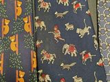 three ties with different designs on them sitting next to each other